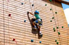 Child climbing the outdoor climbing wall